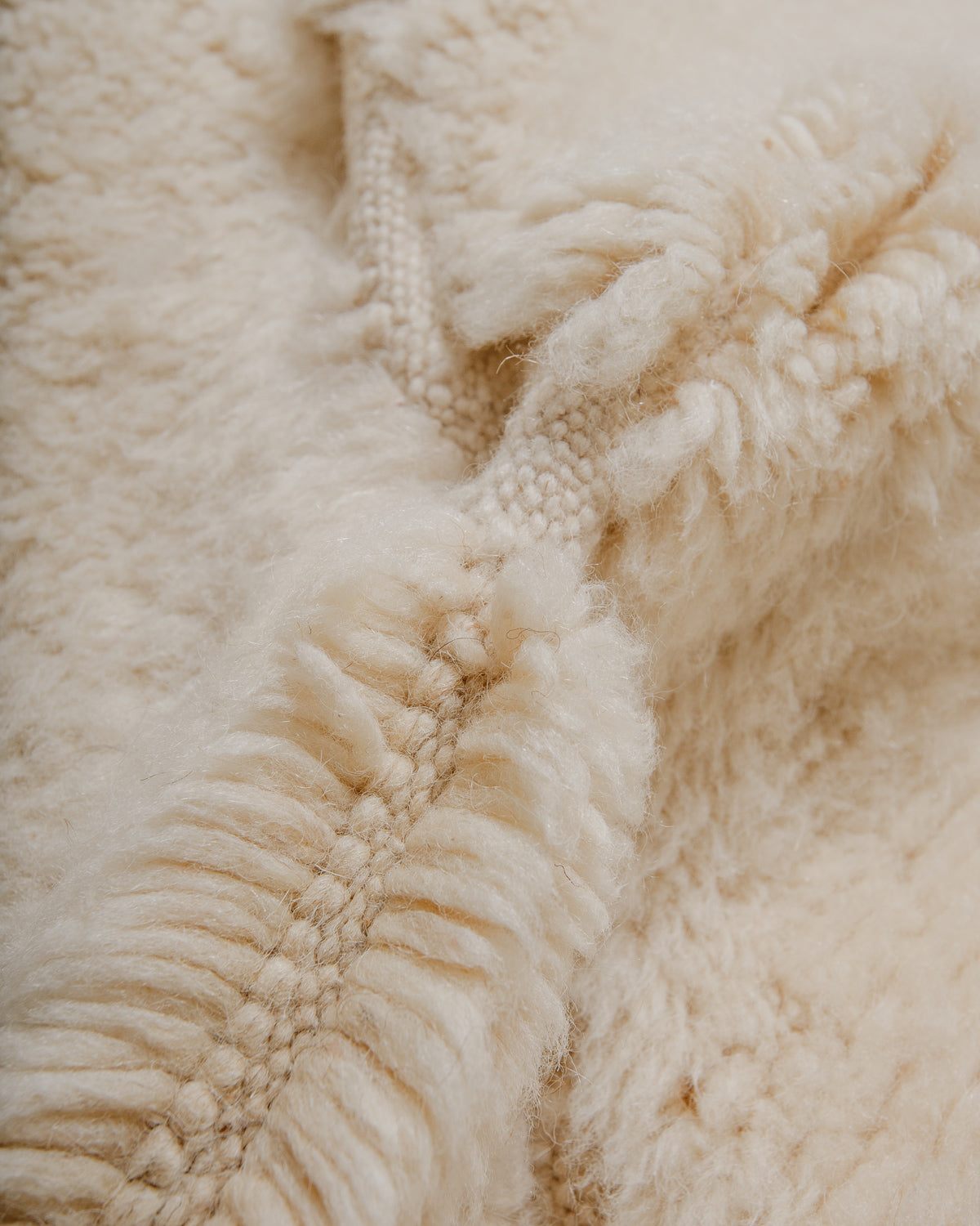 Close-up of a textured cream wool rug